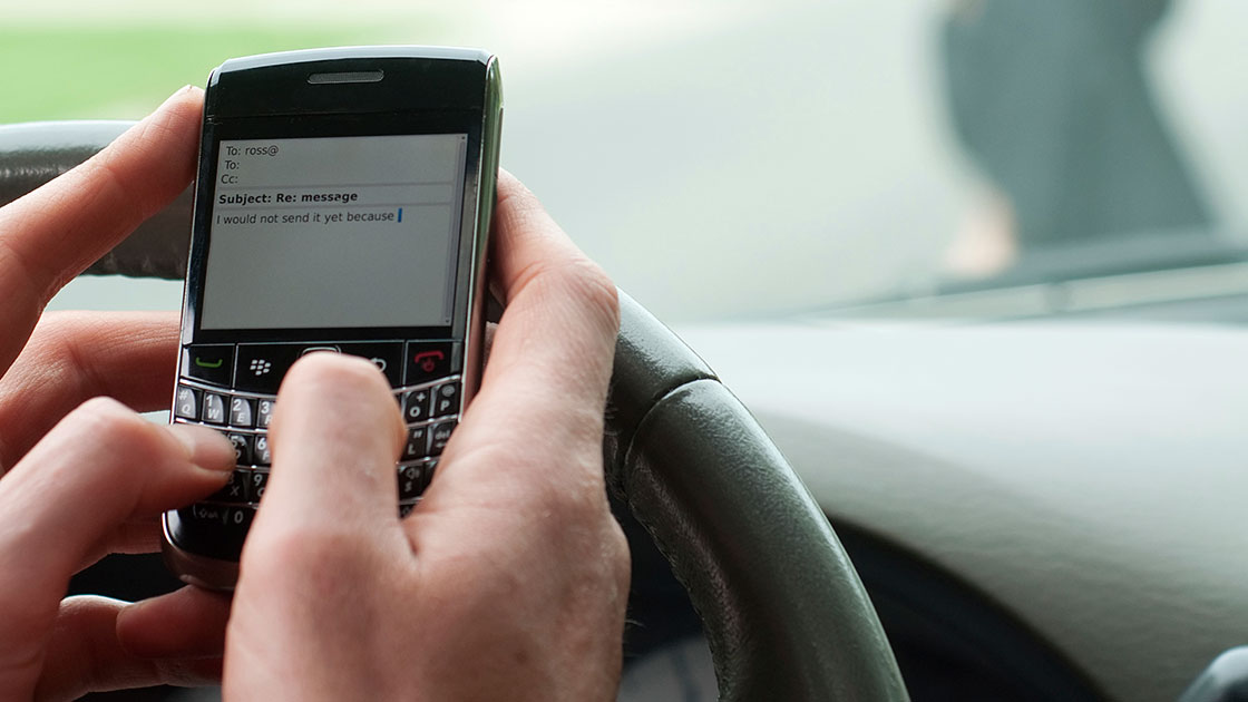 What are some hazards of driving while using your cellphone?