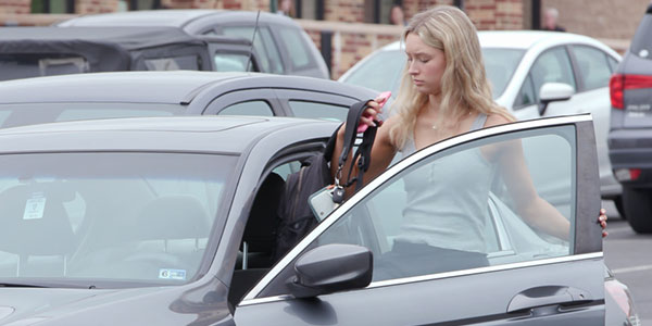 Teenagers getting into driver side of car