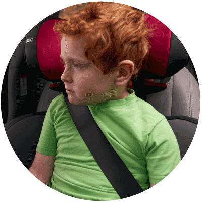 Image of a boy buckled in back seat of car